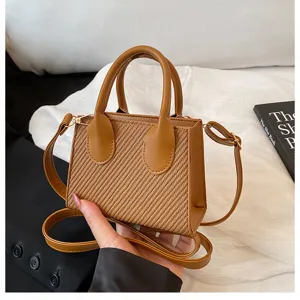 Detailed close-up of the stylish brown straw texture mini handbag showcasing its fine details.