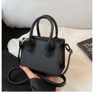 Black mini square crossbody bag for women, chic PU leather handbag with woven texture.