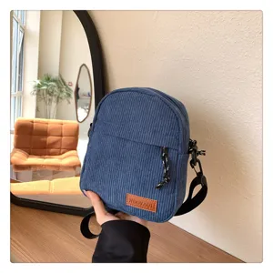 Detailed view of the trendy blue corduroy crossbody bag, stylish and versatile for daily commuting.