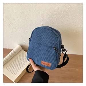 Casual blue corduroy crossbody bag for women, stylish minimalist shoulder bag for daily commute.