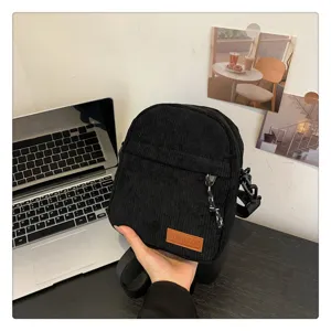 Stylish black corduroy crossbody bag, trendy casual shoulder bag for daily commuting.