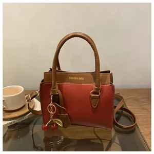 Contrast color women handbag retro crossbody square bag with cute cherry pendant accessory.