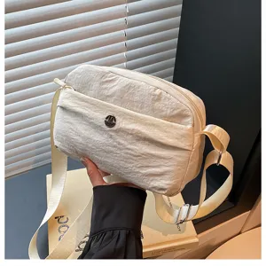 Casual multi-layer crossbody bag for women, lightweight nylon shoulder bag with adjustable strap.