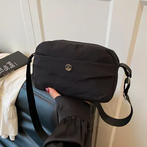 Casual black crossbody bag for women, multi-layer nylon shoulder bag with adjustable strap.