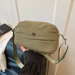 Casual nylon crossbody bag with adjustable wide strap and multi-layer storage pocket.