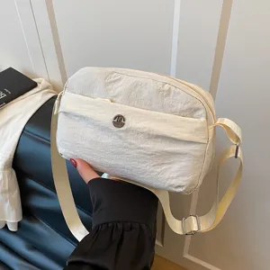 Casual nylon crossbody bag for women, multi-layer shoulder bag with adjustable strap.
