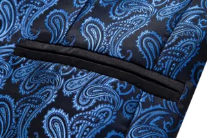 Men's blue paisley jacquard suit jacket detail view, stylish fabric and pocket close up.