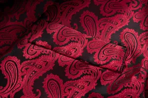 Men's suit jacket pocket detail shot, red and black paisley jacquard fabric design.