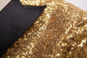 Gros plan détail de vue de veste de blazer pour homme à sequins dorés et revers noir.