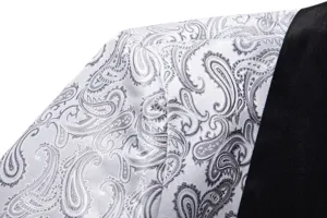 Close-up detail of a men's stylish jacquard paisley suit jacket fabric and lapel design.