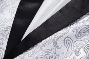Close-up detail of mens elegant black satin lapel paisley jacquard suit jacket fabric.