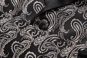 Close-up detail of mens black silver paisley jacquard suit jacket satin lapel button fashion.