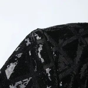 Black sequin blazer jacket shoulder detail, stylish men's dance suit fabric close-up view.