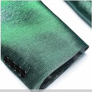Close-up detail view of dark green shimmering suit jacket sleeve with four classic black buttons.