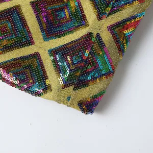 Men's sequin suit jacket detail fabric featuring colorful geometric square patterns on gold.