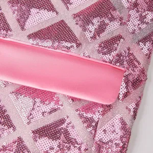 Detail view of pink sequin men suit jacket fabric texture and smooth pink satin lapel.