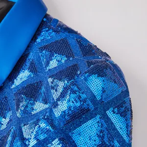 Detail view of men's blue sequin blazer jacket, featuring geometric square pattern and satin lapel.