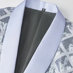 Detailed view of men's sequin blazer jacket featuring light blue lapel and geometric pattern.