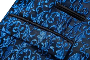 Close-up detail of luxury blue jacquard men's suit jacket fabric with satin pocket trim.