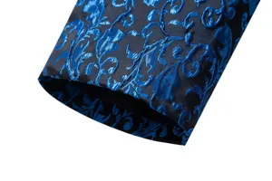 Close-up of a men's blue jacquard suit sleeve detail, showing elegant embroidered pattern.