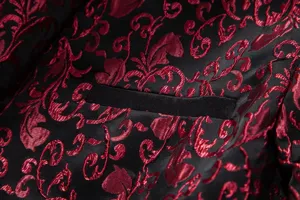 Jacquard blazer detail shot featuring elegant red floral pattern on black fabric with pocket.