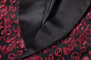 Close-up detail of men's black and red floral jacquard blazer with classic satin shawl lapel.