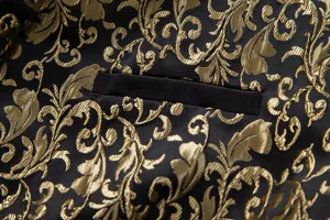Close-up detail of luxury men's black jacket featuring intricate gold floral damask jacquard.