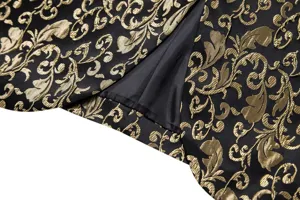 Close-up view of luxury black and gold jacquard suit jacket fabric, back vent detail.