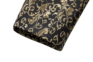 Men's suit jacket sleeve detail, black and gold jacquard fabric, elegant formal wear style.