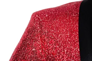 Close-up view of red sequin men's blazer fabric and shoulder detail showing sparkle.