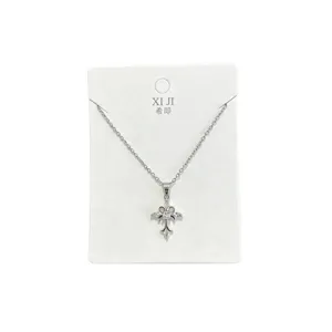 Silver cross pendant necklace, minimalist fine chain jewelry, stylish daily commute accessory.
