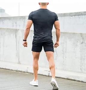 Detail view of men's athletic fitness shorts and t-shirt set in classic black design.