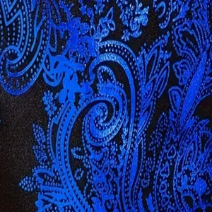 Close-up detail of luxury blue paisley fabric for men fashion suit jacket, elegant style.
