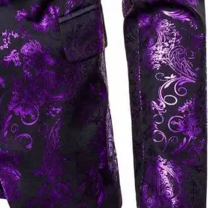 Detail shot of men's purple paisley suit jacket showcasing fabric texture and premium tailoring.