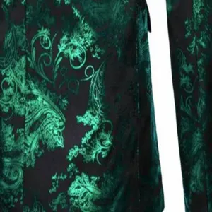 Close-up detail of mens green paisley velvet suit jacket fabric with vintage pattern.