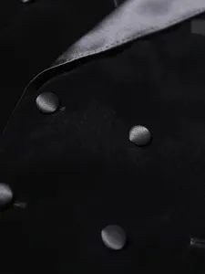 Men black velvet suit jacket detail close-up showing satin lapel and double buttons.