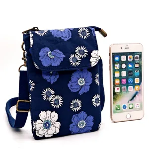 Floral print canvas crossbody phone bag with adjustable strap and vintage hardware design.