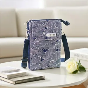 Blue and white leaf pattern crossbody phone bag with strap, multi-layer fabric purse.