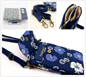 Floral fabric phone bag detail view, multi-layer compartment interior and bronze metal hardware.