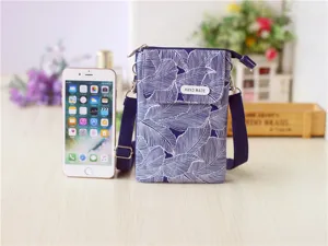 Blue and white leaf pattern fabric crossbody phone bag with adjustable strap for women.