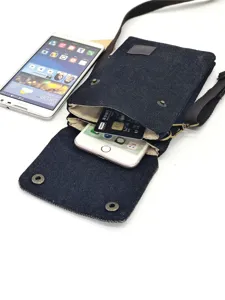 Denim cross-body phone bag detail view showing interior capacity with phone and card slots.