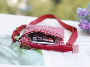 Red ethnic canvas crossbody phone bag with multi layers zipper and adjustable strap for women.