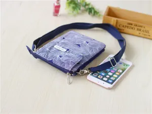 Detail view of the blue leaf print fabric crossbody phone bag with multi-layer pockets.