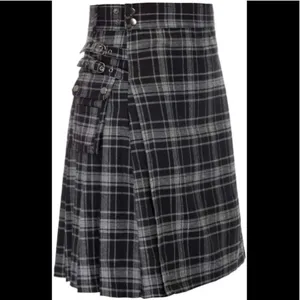 Close-up detail of the black and grey plaid utility kilt with cargo pockets and metal rings.