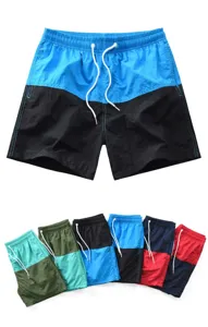 Détail de short de bain homme color-block avec cordon de serrage et multiples options de couleurs.