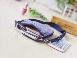 Multi-layer crossbody phone bag detail, ethnic leaf pattern fabric pouch with adjustable strap.