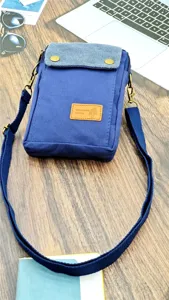 Casual canvas crossbody phone bag for women with adjustable strap and multi-layer design.