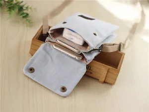 Minimalist denim canvas crossbody phone bag for daily casual use with adjustable strap.