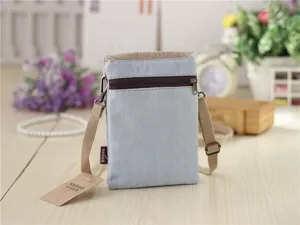 Detailed view of the casual denim canvas crossbody phone bag featuring a handy front zipper pocket.