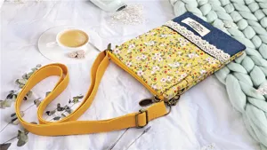 Detail view of the floral fabric crossbody phone bag featuring denim and lace patchwork.